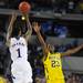 Michigan freshman Caris LeVert looks to block a last seconds shot attempt by Kansas sophomore Naadir Tharpe in the second half and before overtime at Cowboys Stadium in Arlington, Texas on March 29, 2013. Melanie Maxwell I AnnArbor.com